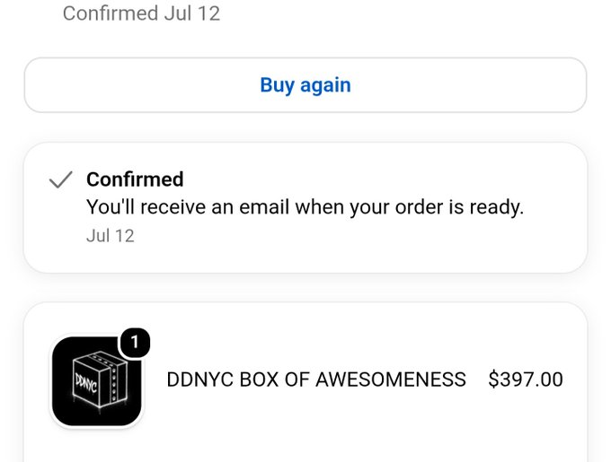 A mobile order confirmation screen showing a "Buy again" button, a "Confirmed" status dated Jul 12, and an item listing for "DDNYC BOX OF AWESOMENESS" priced at $397.00.