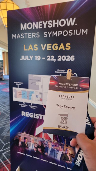 A hand holds a "Speaker" badge reading "Tony Edward" at the MoneyShow Masters Symposium in Las Vegas (July 19-22, 2026), displayed in front of the event's promotional banner ahead of a tokenization talk.