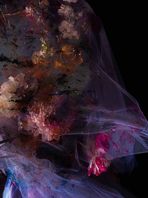 The image features a close-up of flowers, including pink and white ones, arranged against a black background with a sheer fabric draped over them. The flowers are positioned at various angles, creating an interesting visual effect that draws attention to their details. The image is accompanied by a caption that reads "Fine Art on Bitcoin". This suggests that the artist has created this piece as part of a digital art project or exhibition related to cryptocurrency and blockchain technology.

The post also mentions that it's a fine art piece, which further supports the idea that the flowers are part of an artistic creation rather than being actual flowers in real life. The use of a sheer fabric draped over the flowers adds another layer of visual interest, as it creates a sense of depth and texture within the image.