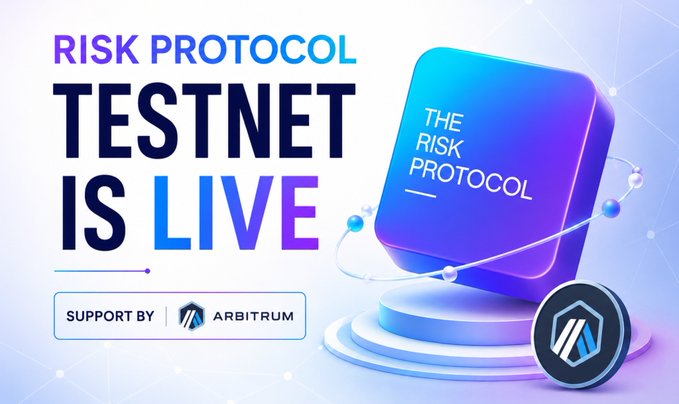The image is a promotional banner announcing that "The Risk Protocol Testnet is LIVE," featuring bold purple and blue text alongside a 3D-rendered cube labeled "THE RISK PROTOCOL" and the Arbitrum logo indicating their support. It visually reinforces the post's message about a free, quick opportunity to engage with The Risk Protocol's testnet for potential future airdrop rewards.
