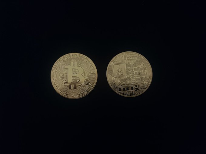 The image shows two gold Bitcoins, one larger than the other, placed against a black background. The text "GM Legends Are you buying BTC during this dip or waiting for a bigger drop before jumping in?" suggests that someone might be considering investing in Bitcoin at this time.