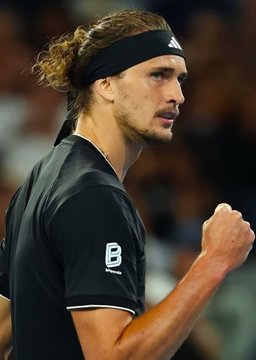 A focused Alexander Zverev, wearing a black Adidas headband and Lotto shirt, clenches his fist in a determined gesture during a match. The image relates to the post, which highlights a massive $1.3 million bet placed on him to defeat Karen Khachanov.