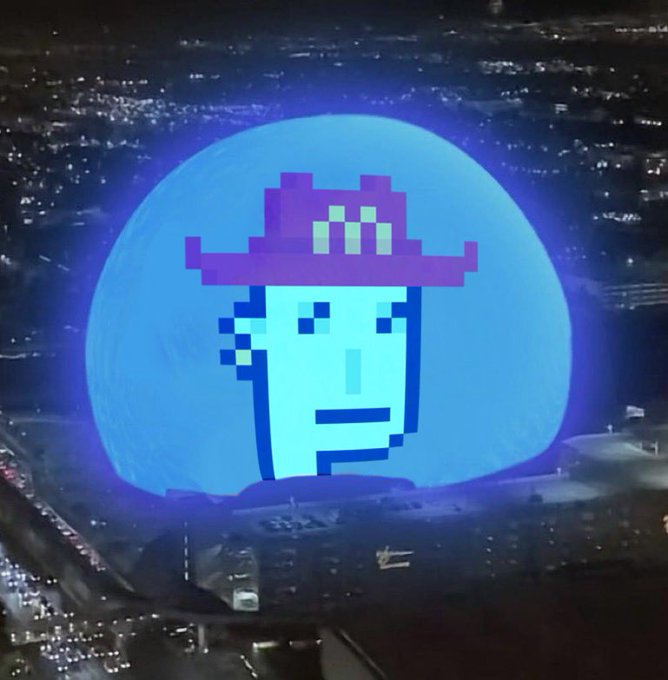 A glowing blue sphere featuring a pixel-art face with sunglasses and a hat, superimposed over an aerial nighttime cityscape.