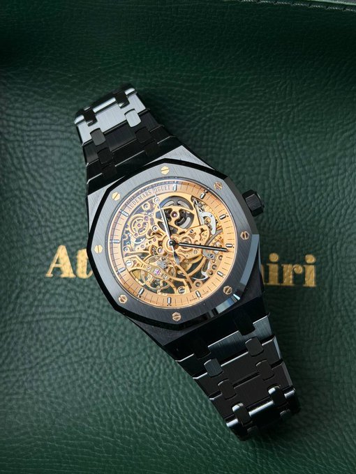 An Audemars Piguet Royal Oak skeleton watch with a black ceramic case, gold-toned movement, and integrated bracelet rests on its dark green branded leather case, symbolizing the post recommends rotating digital trading profits into a tangible luxury timepiece.