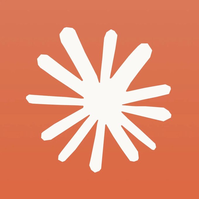 A simple graphic design features a white starburst or sparkle shape centered on a solid orange-red background.