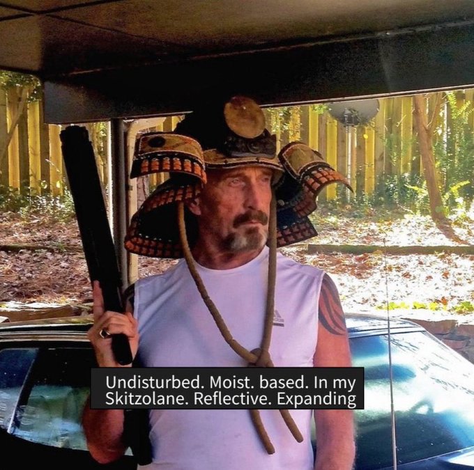 A man wearing a samurai helmet (kabuto) with a white sleeveless shirt holding a sword, with caption text: 'Undisturbed. Moist. based. In my Skitzolane. Reflective. Expanding.'