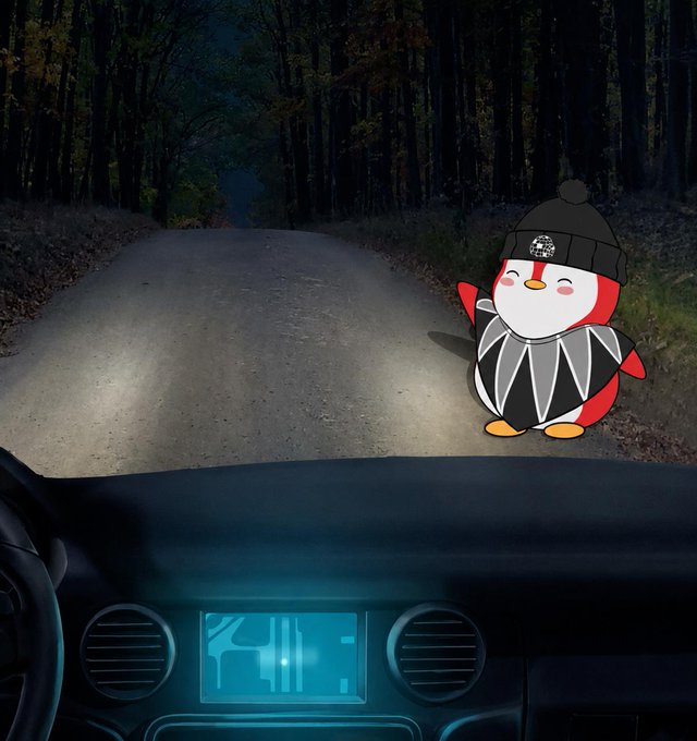 A cartoon penguin wearing a beanie and skateboard sits on a dark forest road illuminated by car headlights, with a glowing dashboard visible in the foreground.
