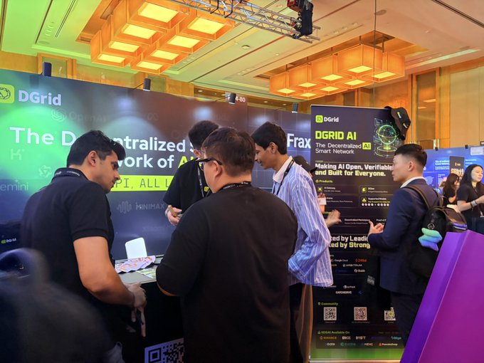 Attendees gather at the DGrid booth (MB4-80) at Token2049 Singapore, engaging with representatives discussing DGrid AI—a decentralized smart network highlighted on the backdrop alongside partner logos including OpenAI, Gemini, and CoinMarketCap.