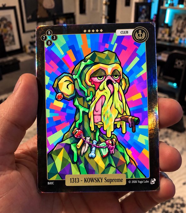 A hand holds a glossy, colorful trading card labeled “CLUB,” “BAYC,” and “1313 - KOWSKY Supreme,” featuring a geometric squid-like character and “© 2026 Yuga Labs.”