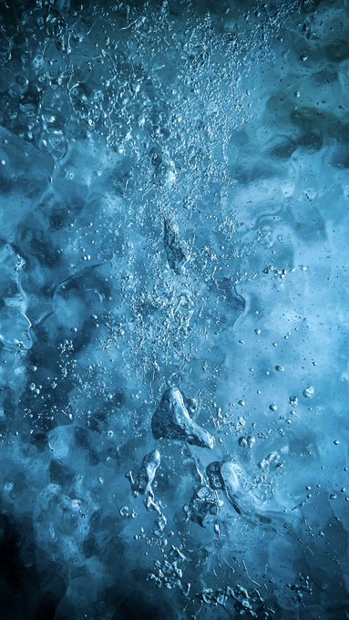 An abstract image shows bubbles and swirling water in deep blue tones, creating an underwater or fluid texture effect.