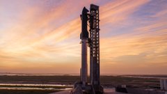 A SpaceX Starship rocket stands tall on the launch pad against a stunning sunset sky, with "SpaceX" visible on the tower, capturing the thrilling anticipation of an upcoming launch.