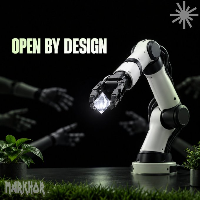 A promotional image featuring a robotic arm holding a glowing diamond with the text 'OPEN BY DESIGN' and 'MARKHOR' displayed against a dark background.