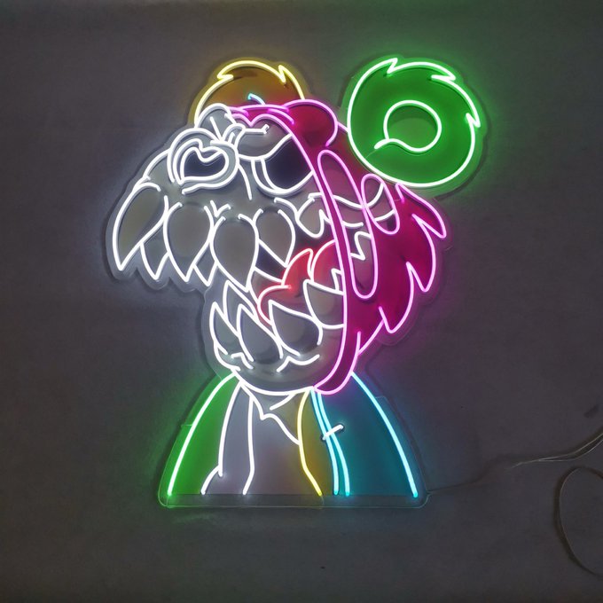 A vibrant neon sign depicting a stylized bear character with colorful hair, balloons, and a rainbow outfit, glowing against a dark background in green, pink, white, yellow, and blue hues. This piece reflects the "Killa Bear" NFT theme mentioned in the post, showcasing the creator's artistic neon interpretation of the beloved collectible character.