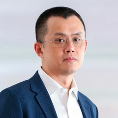 A professional headshot of CZ, the former CEO of Binance, shown wearing glasses and a navy blue blazer with a white shirt. The image relates to the post describing how Binance's founder accidentally burned 4,444 MarsCoin tokens while cleaning out his wallet.