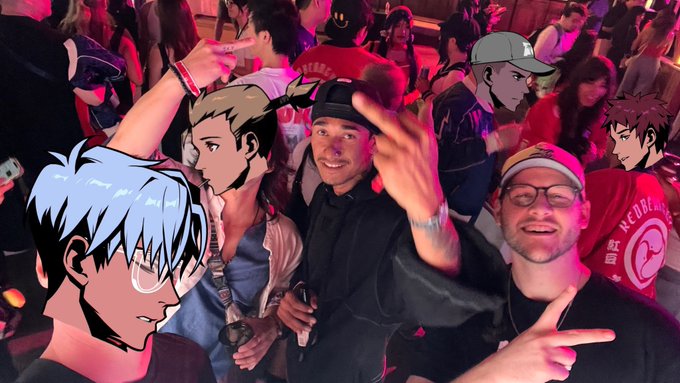 Two men pose for a photo at a club with anime character faces digitally placed over several people in the crowd.