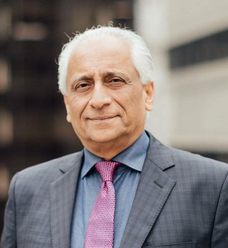 The image features a man wearing a suit, tie, and looking directly at the camera with a smile. The caption reads "INSANE: Former Ripple executive says $XRP is not designed for retail. Every $XRP will be like gold." This statement seems unrelated to the main subject of the photo - the man in the suit. It appears that someone has posted this image on social media, possibly as part of a conversation or trend related to cryptocurrency and digital currency.