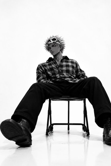 A black-and-white photo features an anime-style spiky-haired character sitting casually on a folding chair with legs spread wide, wearing a plaid shirt and dark pants.
