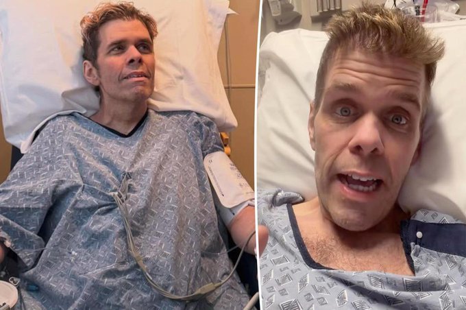 A man with reddish-blonde hair lies in a hospital bed wearing a blue patterned gown, with medical wires and a blood pressure cuff visible on his arm. His wide-eyed, distressed expression in the close-up shot reflects the harrowing circumstances described in the post about the disturbing livestream incident.