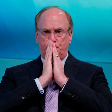 Larry Fink, CEO of BlackRock, is shown with his hands clasped together in a contemplative pose. The image relates to the post about BlackRock's significant Bitcoin ETF sale, highlighting the financial giant's major move in the crypto market.