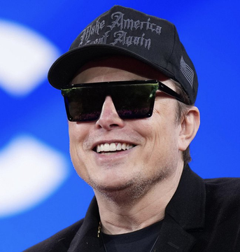A smiling man wearing dark sunglasses and a black cap reading "Make America Great Again" appears on a blue-lit stage, with the post announcing that Elon Musk's X platform now enables users to purchase $BTC directly within the app.