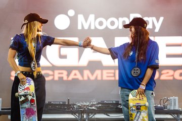 Two skaters in matching dark blue jerseys bump fists on stage at the MoonPay X Games League Sacramento 2025, with the event branding displayed behind them. The "25" logo and "MoonPay" text are visible on the backdrop and apparel, tying in with the post celebrating Team XC São Paulo's gold medal wins in Skate and BMX.