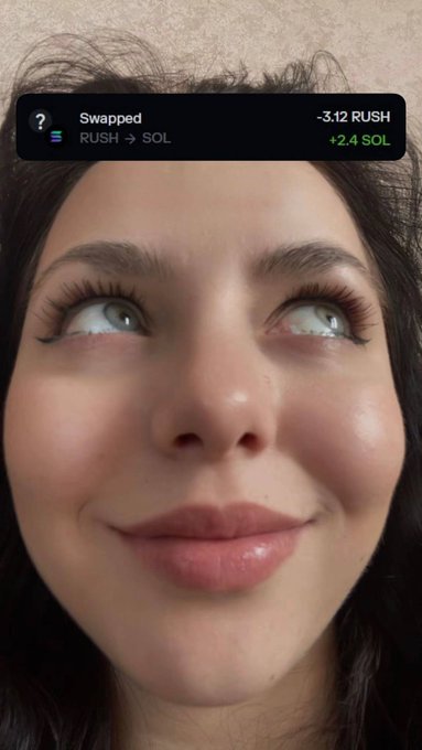 A close-up selfie of a woman looking upward, with a notification banner overlaying the image that reads 'Swapped -3.12 RUSH RUSH → SOL +2.4 SOL' indicating a cryptocurrency token swap.
