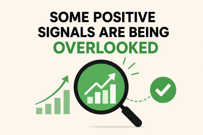 Infographic with text 'SOME POSITIVE SIGNALS ARE BEING OVERLOOKED' above an illustration of a magnifying glass examining a bar chart with an upward arrow, accompanied by a green checkmark.