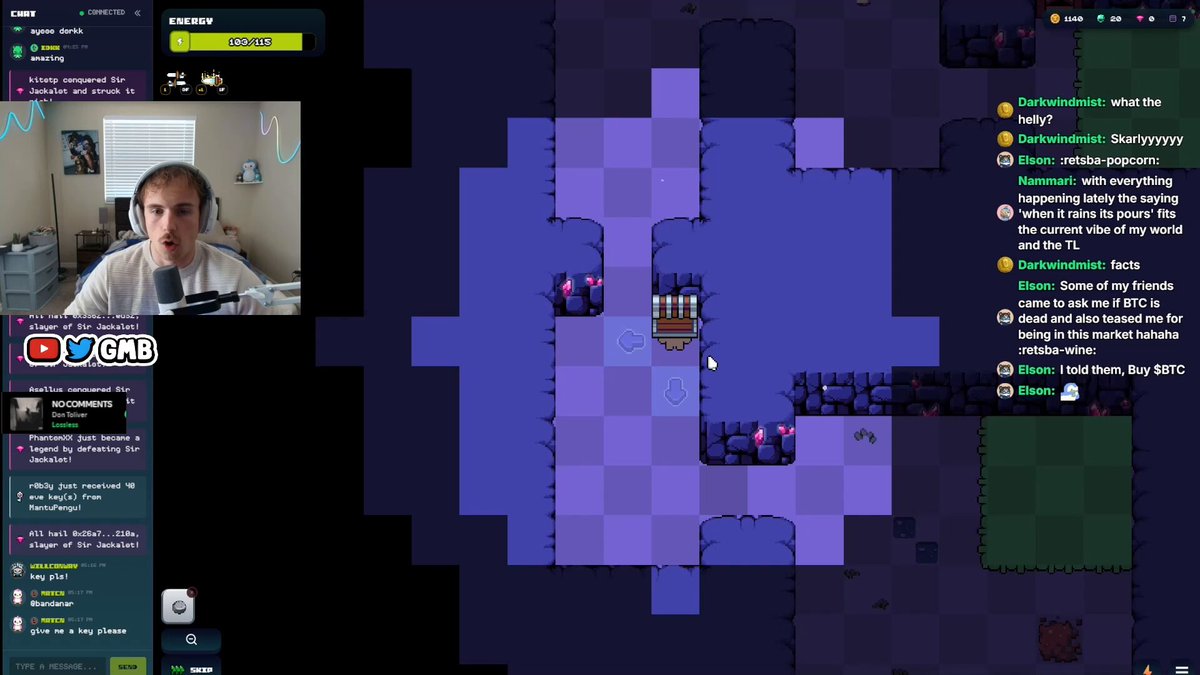 The image shows a man sitting at his computer, playing a video game with a chat window open beside him. The game appears to be a maze or puzzle game, as indicated by the purple background of the screen. There are several other people present in the chat box, suggesting that they might be discussing strategies or sharing their experiences while playing the game together.