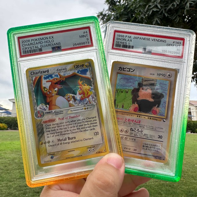 Two PSA-graded Pokémon cards in protective slabs held up outdoors: a 2006 Pokémon EX Charizard-Holo Crystal Guardians #4 graded PSA 9 MINT, and a 1998 P.M. Japanese Vending Snorlax #143 graded PSA 10 GEM MINT.
