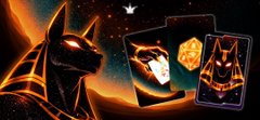 urn of gold, two cards with a cat and a dragon, and a book with a cat on the cover are arranged diagonally against a dark blue background.