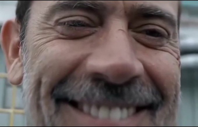 The image shows an extreme close-up of a middle-aged man with a salt-and-pepper beard, grinning broadly with his teeth showing and eyes crinkled in genuine amusement. The tight framing emphasizes the intensity of his smile, capturing a candid moment of hearty laughter that fits the post's "That's Extremely Interesting" reaction.