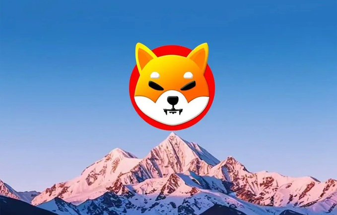 Stylized logo of an orange and white Shiba Inu dog face on a red circle, set against a blue sky and snow-capped mountain backdrop.