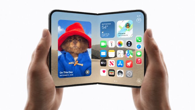 A person holds a foldable smartphone displaying the iconic "On This Day, September 9, 2008" wallpaper of Paddington Bear, with a home screen showing a 54° weather widget, app icons, and the time 9:41. The image playfully ties into the post's joke by visually supporting the concept of an iPhone with two screens—one showing the charming Paddington wallpaper and the other filled with apps.