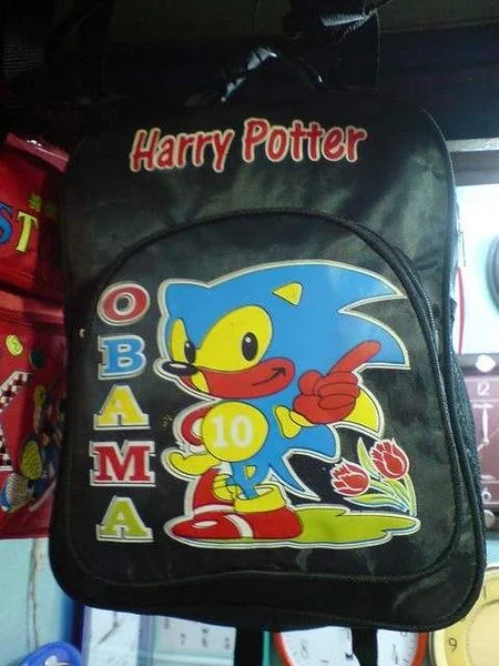 A black Harry Potter-themed backpack features a Sonic the Hedgehog character design with 'Obama' spelled vertically and a '10' on his belly, displayed on a store shelf.