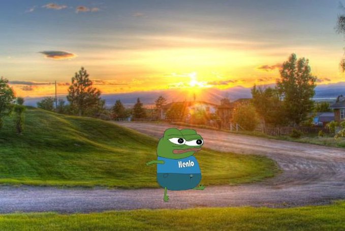 A green cartoon frog wearing a shirt labeled "Ilenio" stands on a country road against a beautiful sunset backdrop, complementing the cheerful "gm amigos, TGIF, Have a wonderful day!" message with a warm, uplifting Friday morning greeting vibe.