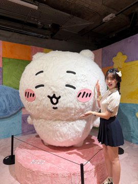 A woman poses next to a giant fluffy white bear mascot with pink cheeks at what appears to be a themed pop-up or store. The "$HYPE" ticker reference and bear imagery playfully evoke the bullish enthusiasm for Hyperliquid's token, with the cute bear mascot symbolizing the "to the moon" excitement expressed in the post.