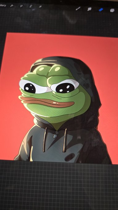 A digital illustration of a Pepe the Frog character wearing a dark hoodie with drawstrings, displayed on a red background on what appears to be a drawing tablet screen.