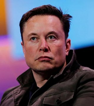 A close-up portrait of Elon Musk wearing a brown leather jacket, looking off to the side against a blurred purple and blue background.