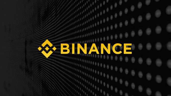 The image features a logo of the cryptocurrency Bitcoin displayed against a black background. The text "Binance" appears below the Bitcoin logo, indicating that the image may be promoting or discussing Bitcoin as a cryptocurrency service for U.S. users with a zero commission payment system and fractional share purchases starting at $5.