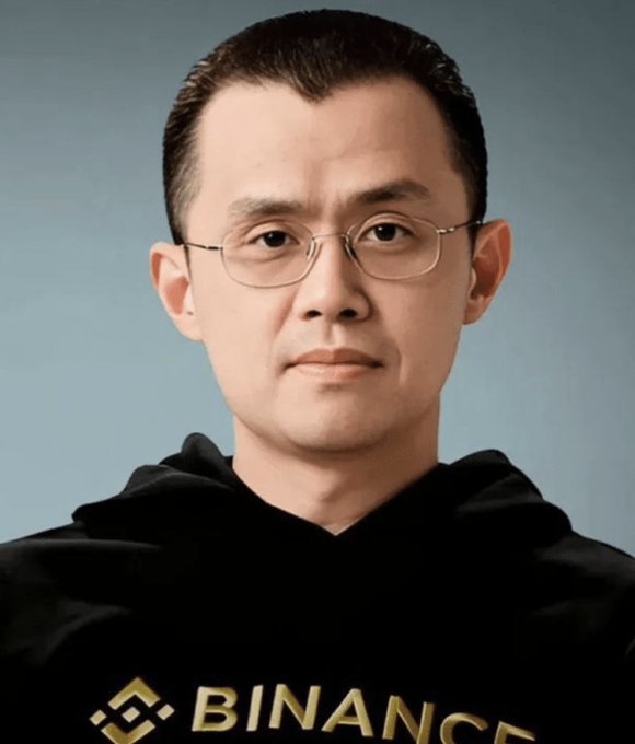 A man wearing glasses and a black hoodie with the yellow "BINANCE" logo and text across the chest appears in a portrait photo. The Binance branding ties into the "former employee" caption, suggesting he previously worked at the cryptocurrency exchange company.