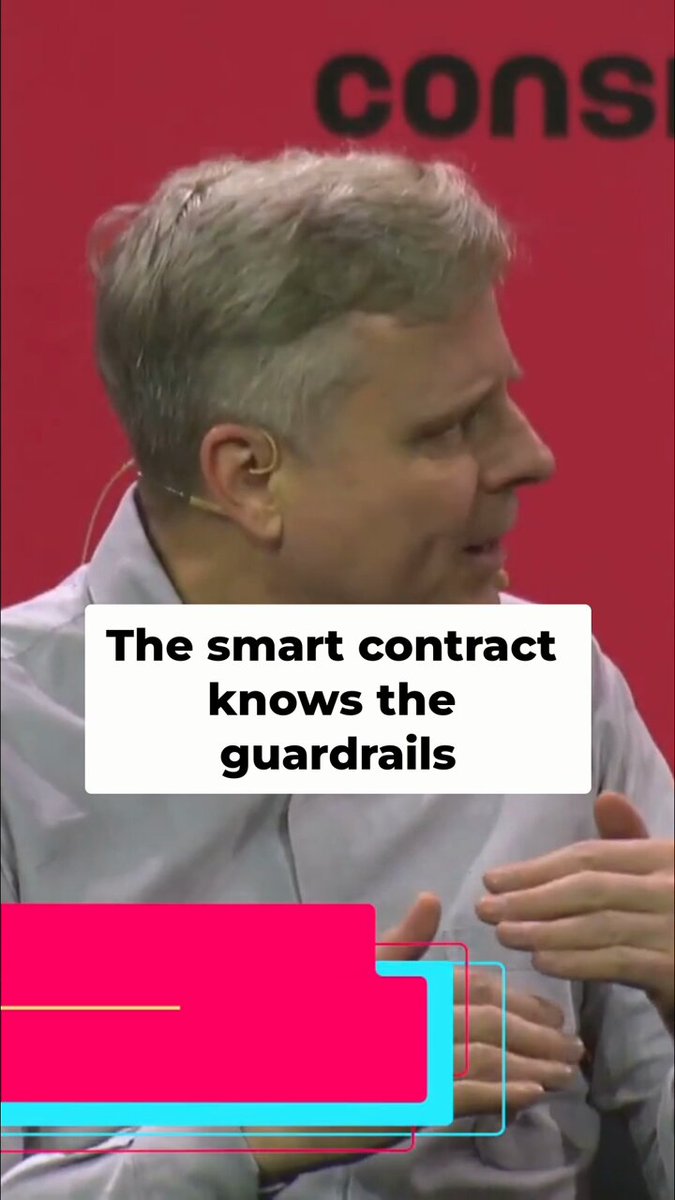 The image features a man wearing a grey shirt, with his hands placed on his knees as he speaks into a microphone. The background shows a red wall with the text "CONS" written on it. Below this, there's a pink banner that reads "THE SMART CONTRACT KNOWS THE GUARDRAILS".
