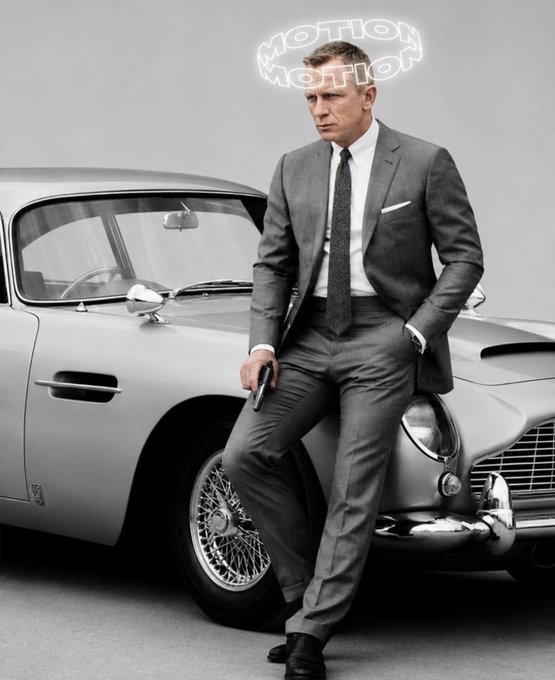 Daniel Craig leans against a silver Aston Martin sports car in a sharp gray suit, with a glowing neon 'MOTION MOTION' sign above him against a minimalist studio background.