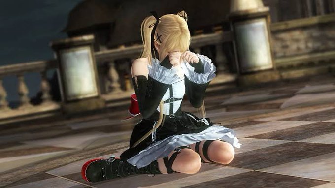 A 3D-rendered anime-style blonde character in a black and white gothic maid outfit, kneeling on a stone floor with her hands raised near her face.