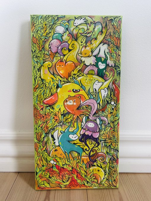 A vibrant, colorful painting leans against a wall on a wooden floor, depicting whimsical creatures and foliage in a dense, illustrative style.
