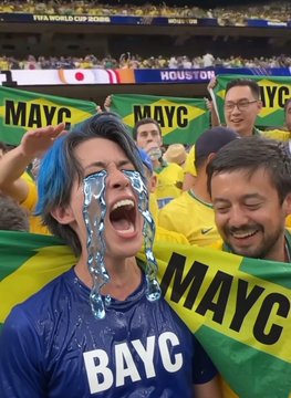 Crowd photo of sports fans in yellow and blue BAYC jerseys cheering, with one person crying blue tears, set at the FIFA World Cup 2026 in Houston.