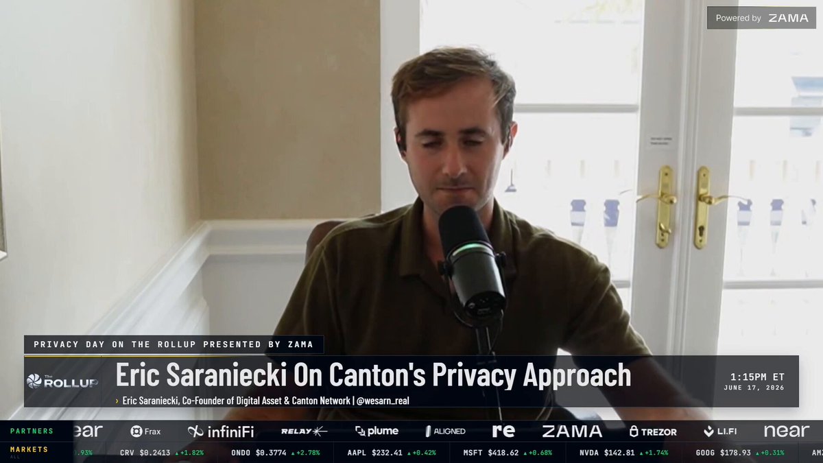 The image shows a man sitting at a desk with a microphone, wearing a green shirt. The background features a window overlooking a white door. There are several logos displayed around the room, including "Focus" and "TradingFi". A caption below the image reads "Co-founder of CantonNetwork says the TradFi unlock is closer than anyone thinks and it' s happening in months, not years."