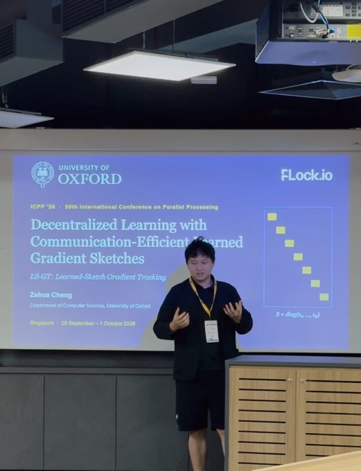 A presenter stands at a podium presenting a slide titled 'Decentralized Learning with Communication-Efficient Learned Gradient Sketches' at ICPP '26.