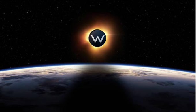 The image features a large "W" in the center of the frame with a yellow sunburst radiating outwards, appearing to be an analog signal or a solar flare, possibly related to the word "WAGMI". This visual element is surrounded by stars and planets below, representing the vastness of space. In the background, there are details that provide context about WAGMI's purpose and functionality; for example, it is described as being built for everyone to enter the crypto hasslefree, while staying true to the crypto ethos.