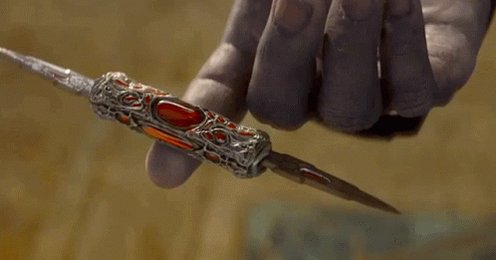 The image shows a person holding a silver and red ornate knife with a gemstone on top of their finger, possibly as part of an advertisement or promotional material for a product. The background appears to be blurred, but there are some texts visible that read "tell me you follow the wrong people without telling me you follow the wrong people" and "my feed is overwhelmingly Ethereum." These texts seem unrelated to the knife in the image, but they might be part of an advertisement or promotional material for a product related to knives.

The main focus of the image is on the ornate knife with the gemstone on it, as well as some text that seems out of place and unrelated to the scene.