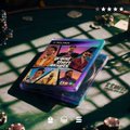 A small trading card or token sits on a checkered surface, featuring colorful artwork and what appears to be the Take-Two Interactive logo, visually representing the newly listed $TTWO token mentioned in the post. The card's design symbolizes the tokenization of Take-Two Interactive, the publisher behind major gaming franchises like GTA 6.
